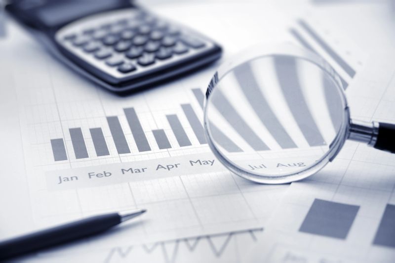 Business analytics with calculator and bar charts